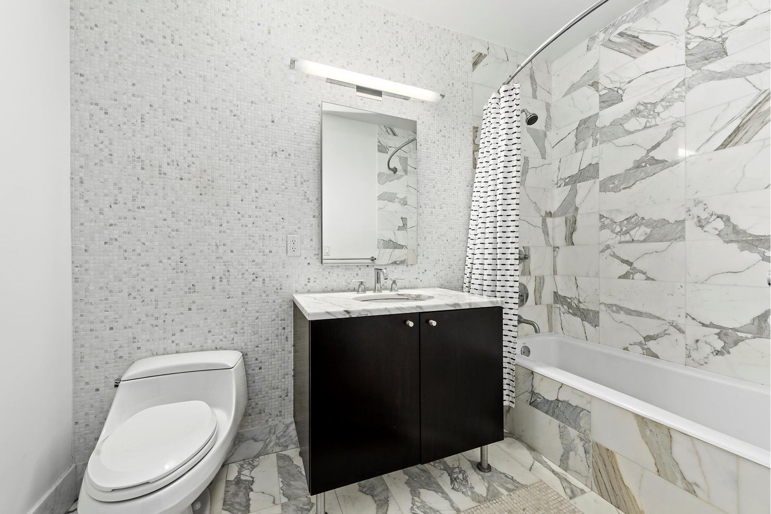 46-30 Center Boulevard, Unit 1106 Queens, NY 11109 - Photo 6 of 9 a bathroom with a sink and a toilet