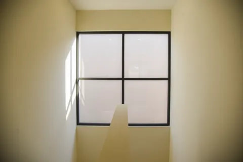 a view of a hallway and a door