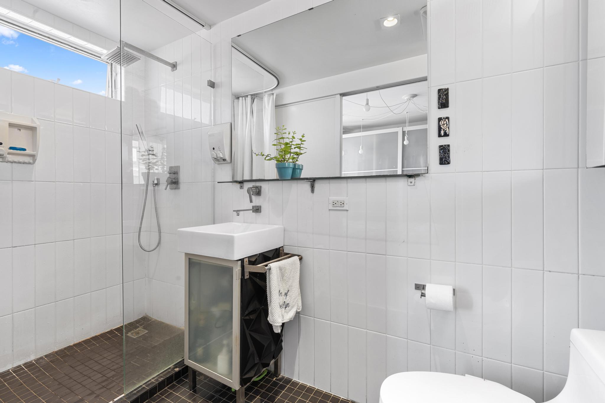 1311 Pacific Street, Unit 405 Brooklyn, NY 11216 - Photo 5 of 9 a bathroom with a sink toilet and shower