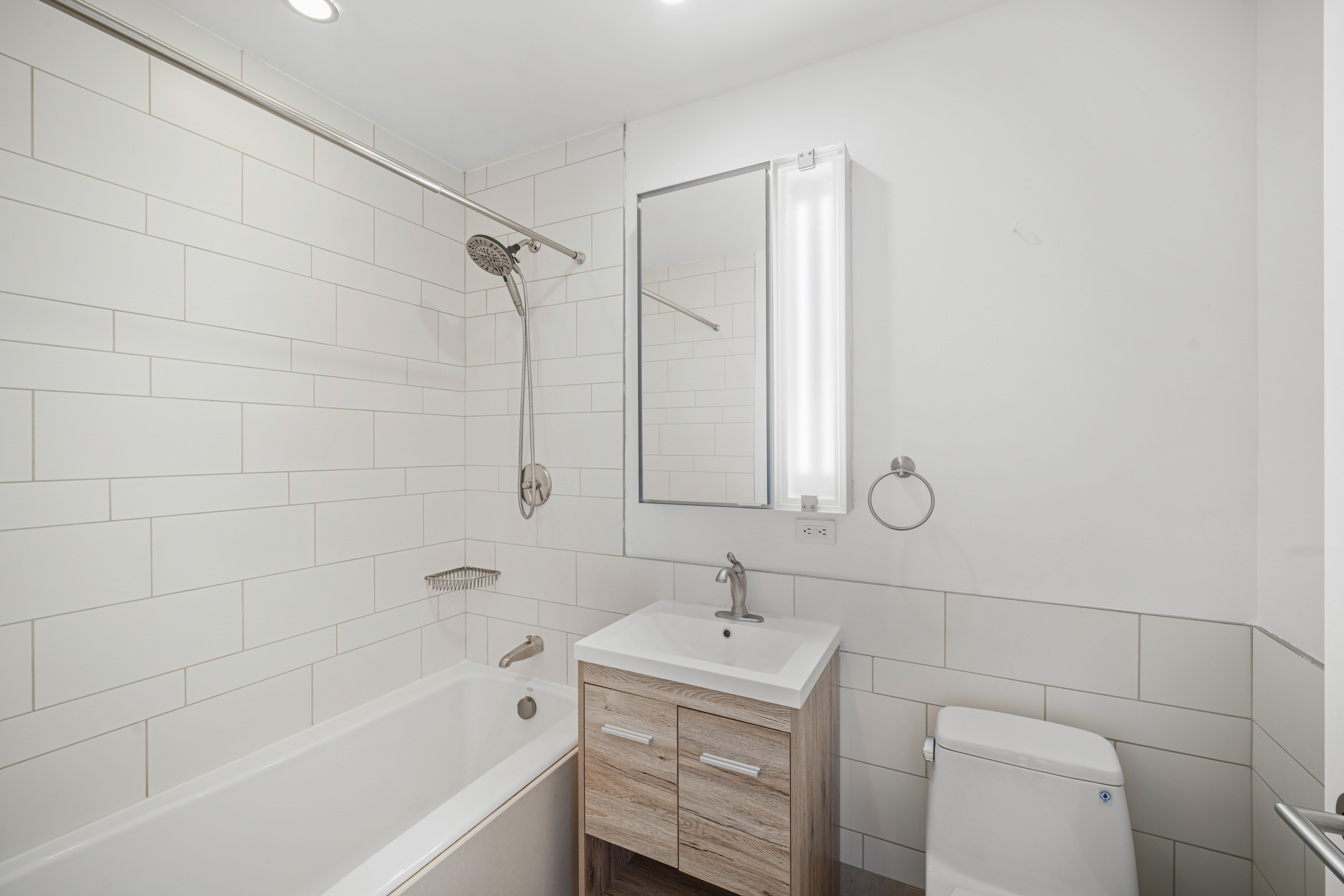 450 East 83rd Street, Unit 9E Manhattan, NY 10028 - Photo 11 of 18 a bathroom with a sink a toilet and shower