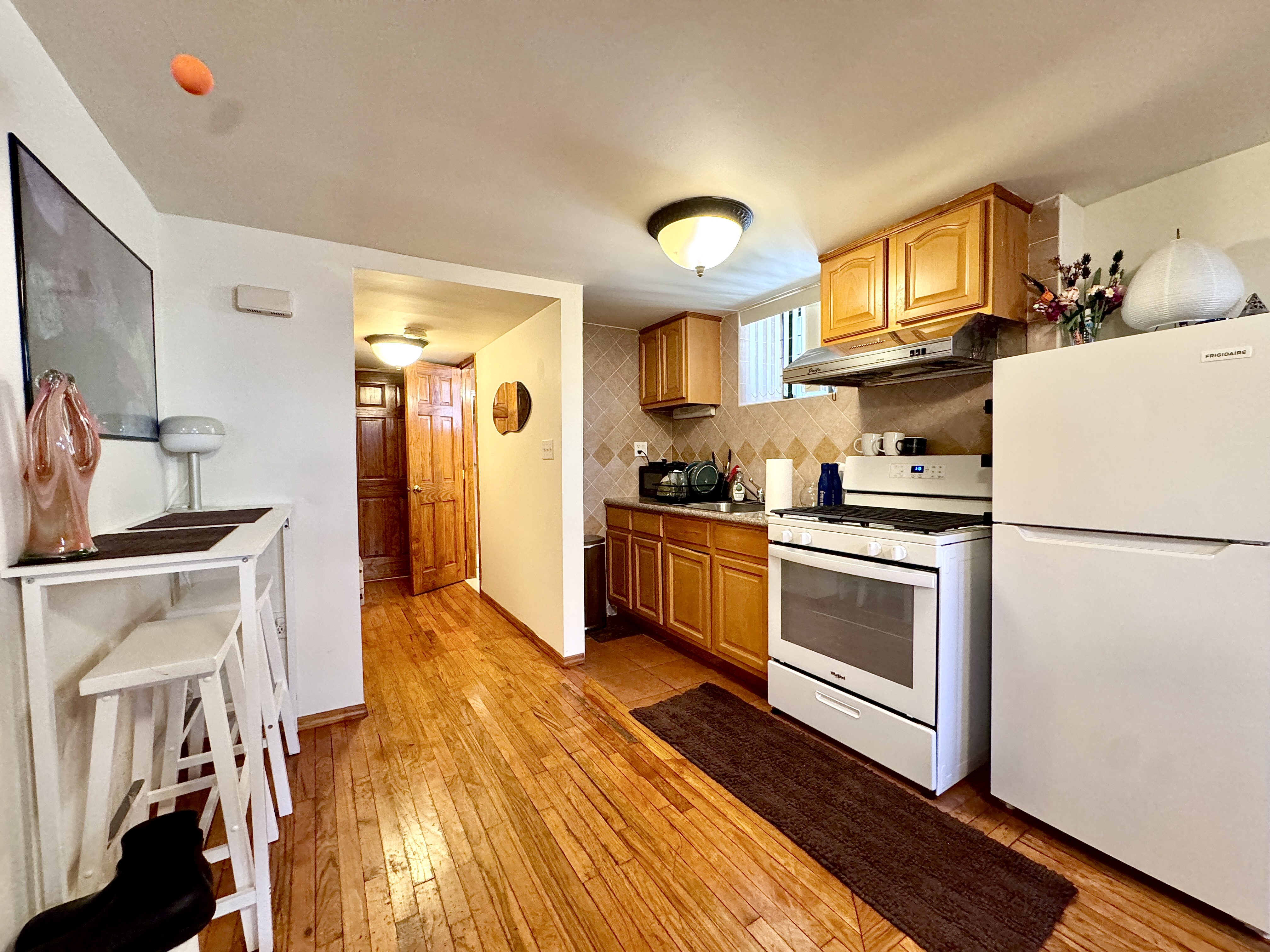 1561 Carroll Street, Unit Undisclosed Brooklyn, NY 11213 - Photo 5 of 9 a kitchen with a sink a refrigerator and cabinets
