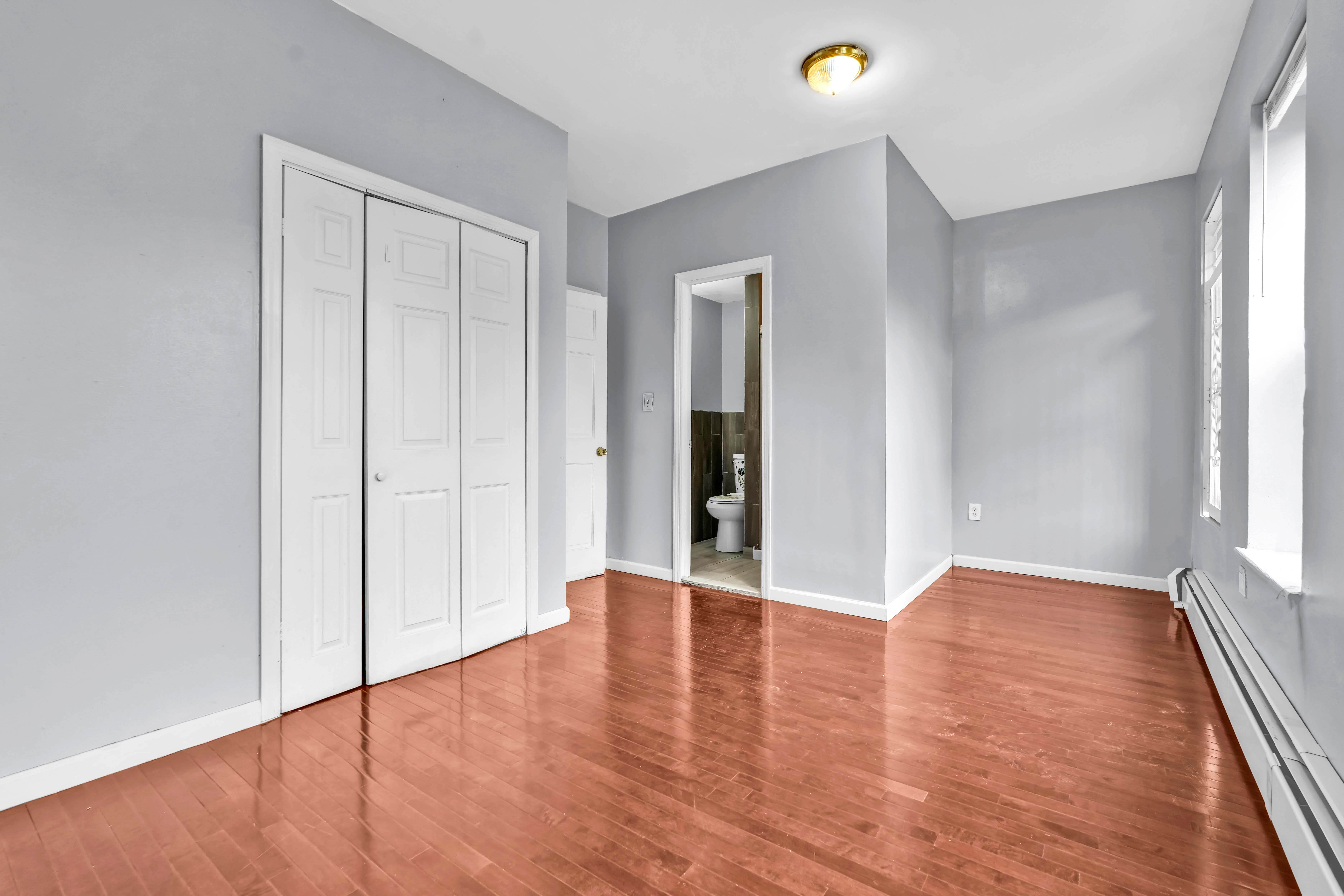 1633 St Johns Place, Unit 3 Brooklyn, NY 11233 - Photo 11 of 29 a view of an empty room with wooden floor and a window