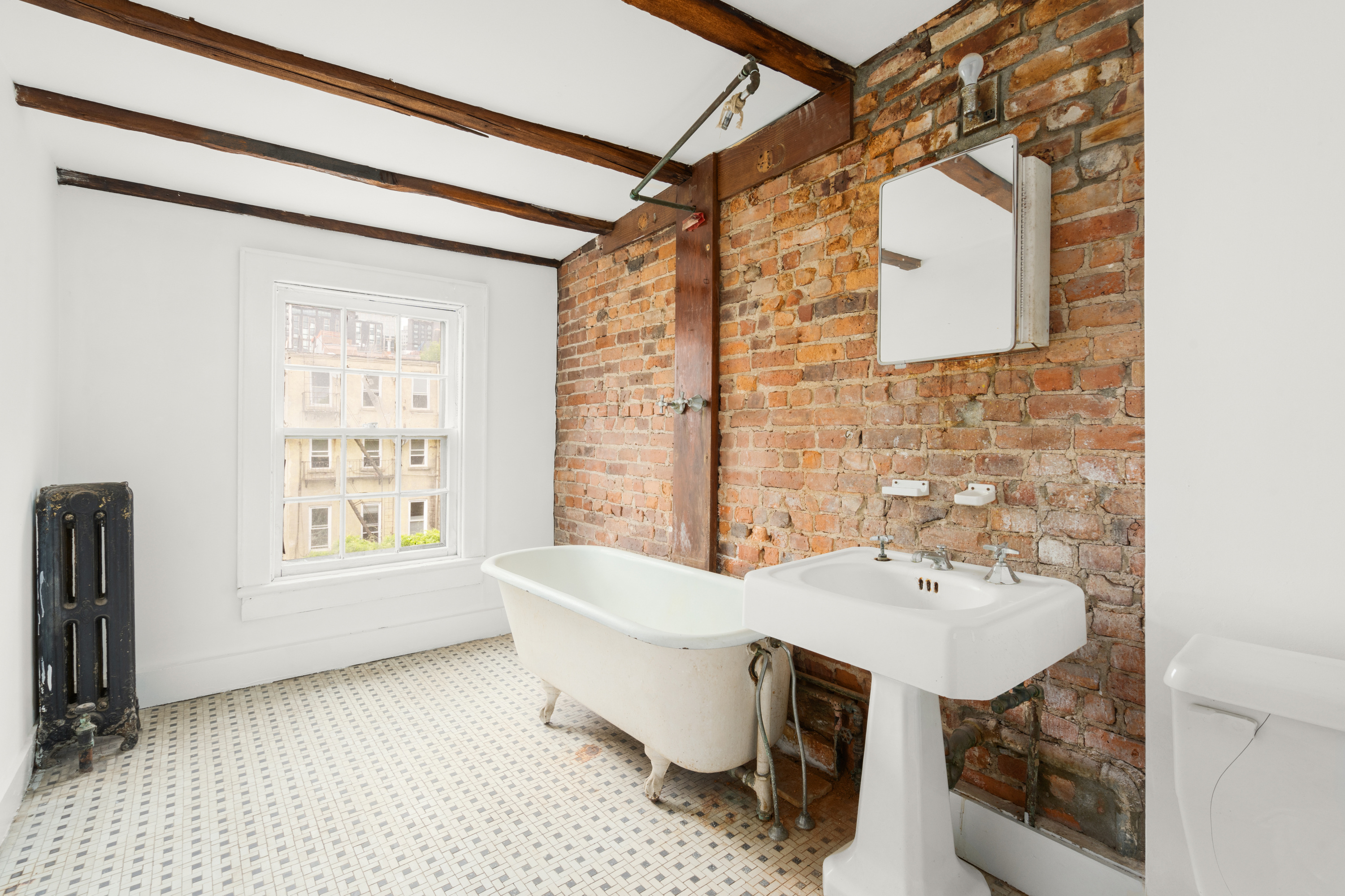 217 Dean Street Brooklyn, NY 11217 - Photo 19 of 26 a bathroom with a sink mirror and a bathtub