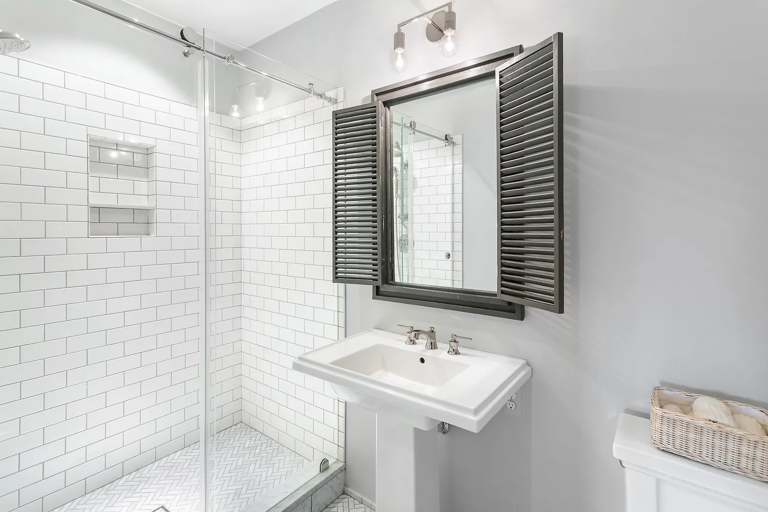 a bathroom with a sink a mirror and shower