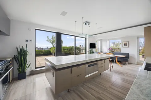 a view of a living room and kitchen with a large window