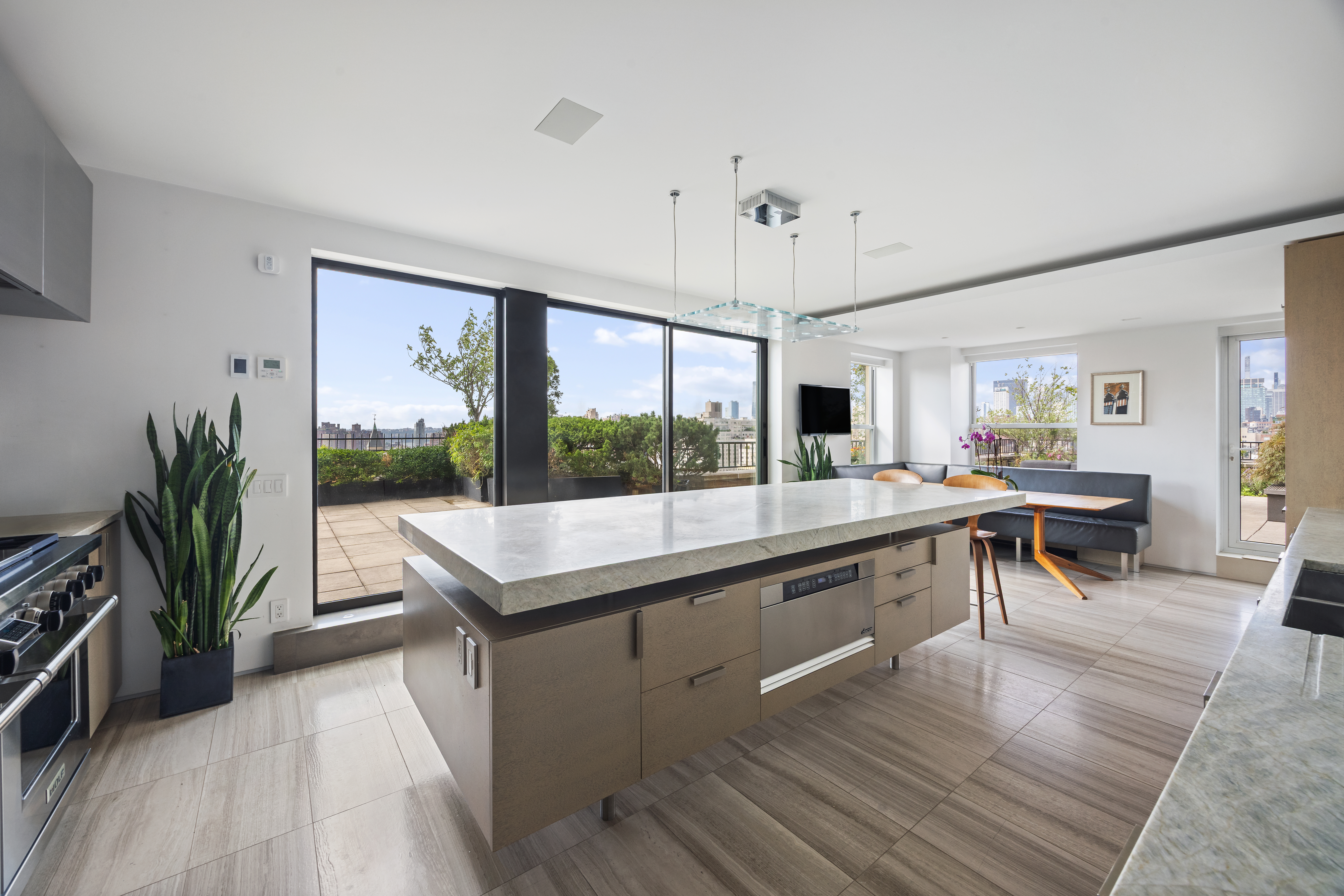 24 5th Avenue, Unit PH1701 Manhattan, NY 10011 - Photo 23 of 24 a view of a living room and kitchen with a large window