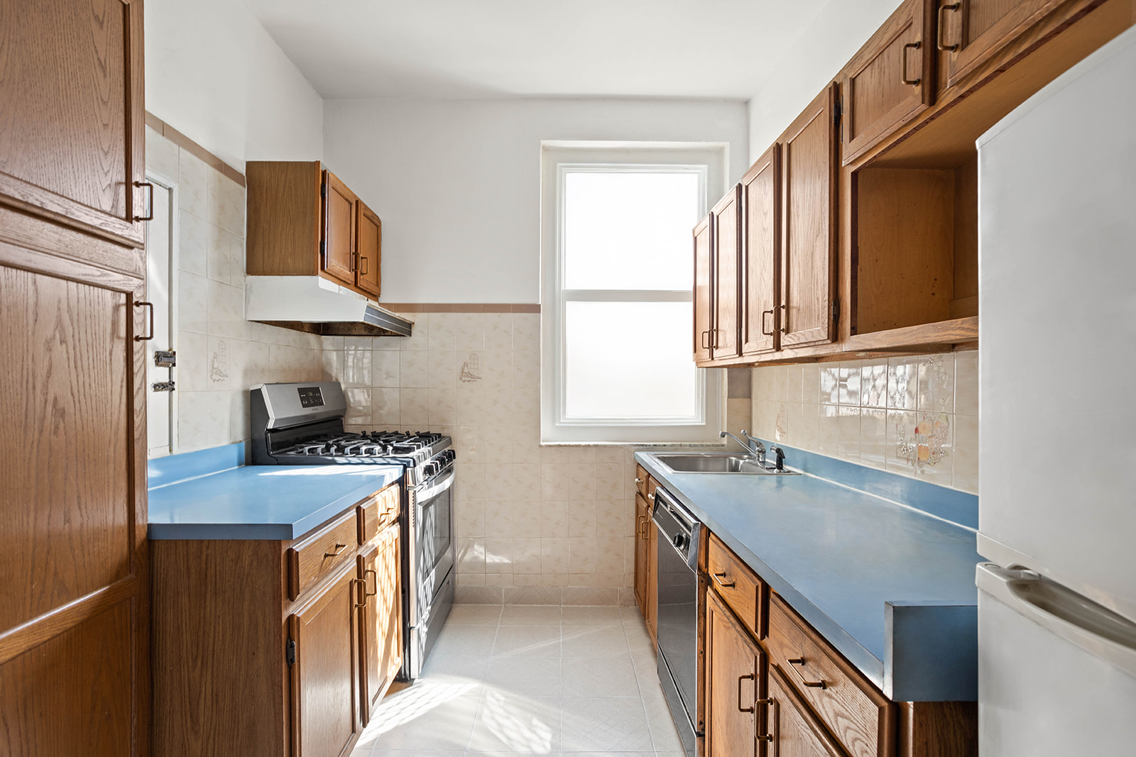 35-55 78th Street, Unit 42 Queens, NY 11372 - Photo 3 of 11 a kitchen with stainless steel appliances granite countertop a sink stove and refrigerator
