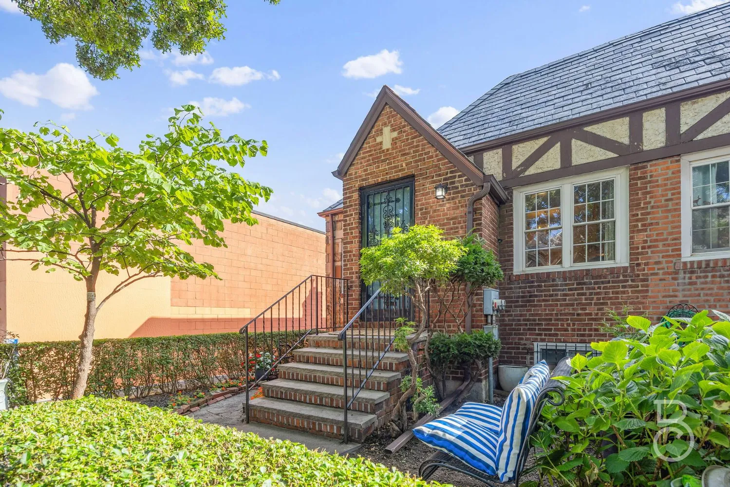 a front view of a house with a garden