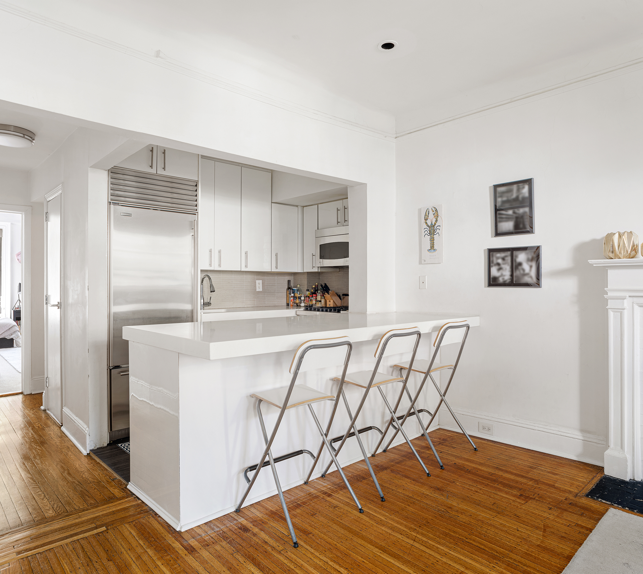 159 East 63rd Street, Unit 2/3 Manhattan, NY 10065 - Photo 5 of 13 a kitchen with stainless steel appliances granite countertop a refrigerator and a stove top oven