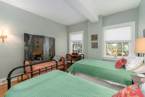 a bedroom with two beds and a window