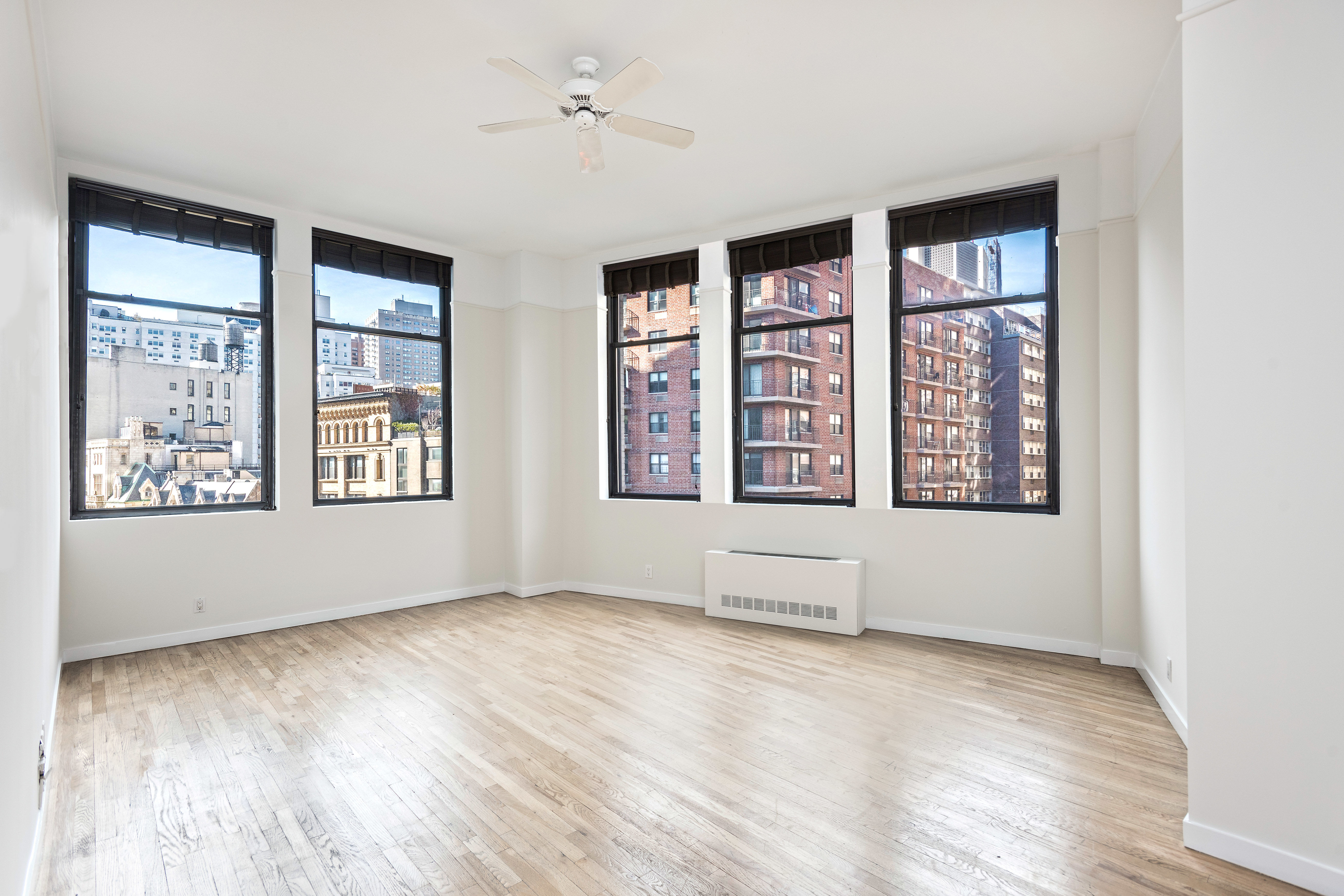 115 4th Avenue, Unit 5C Manhattan, NY 10003 - Photo 2 of 11 a view of an empty room with a window and wooden floor