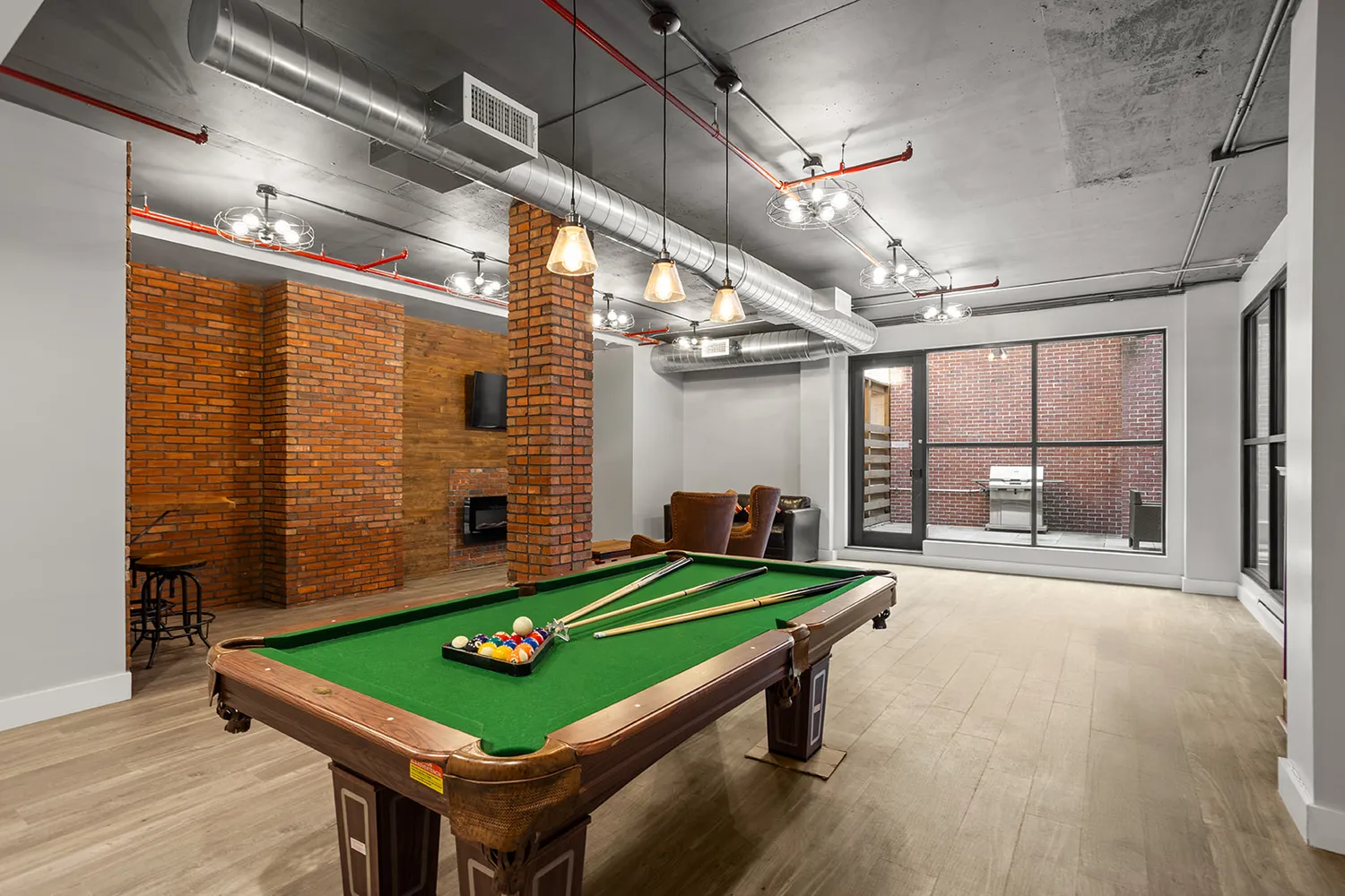 a room with pool table and windows