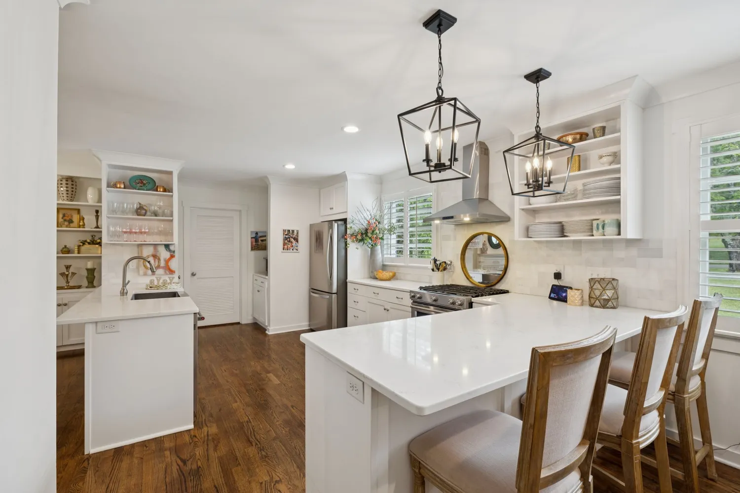 a kitchen with appliances cabinets and a potted plant