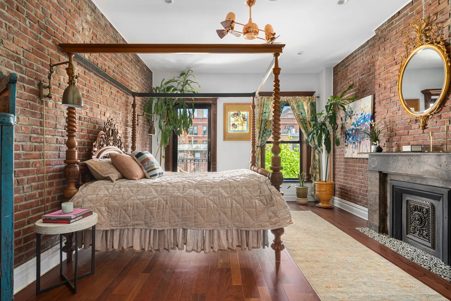 a living room with furniture a fireplace and a floor to ceiling window