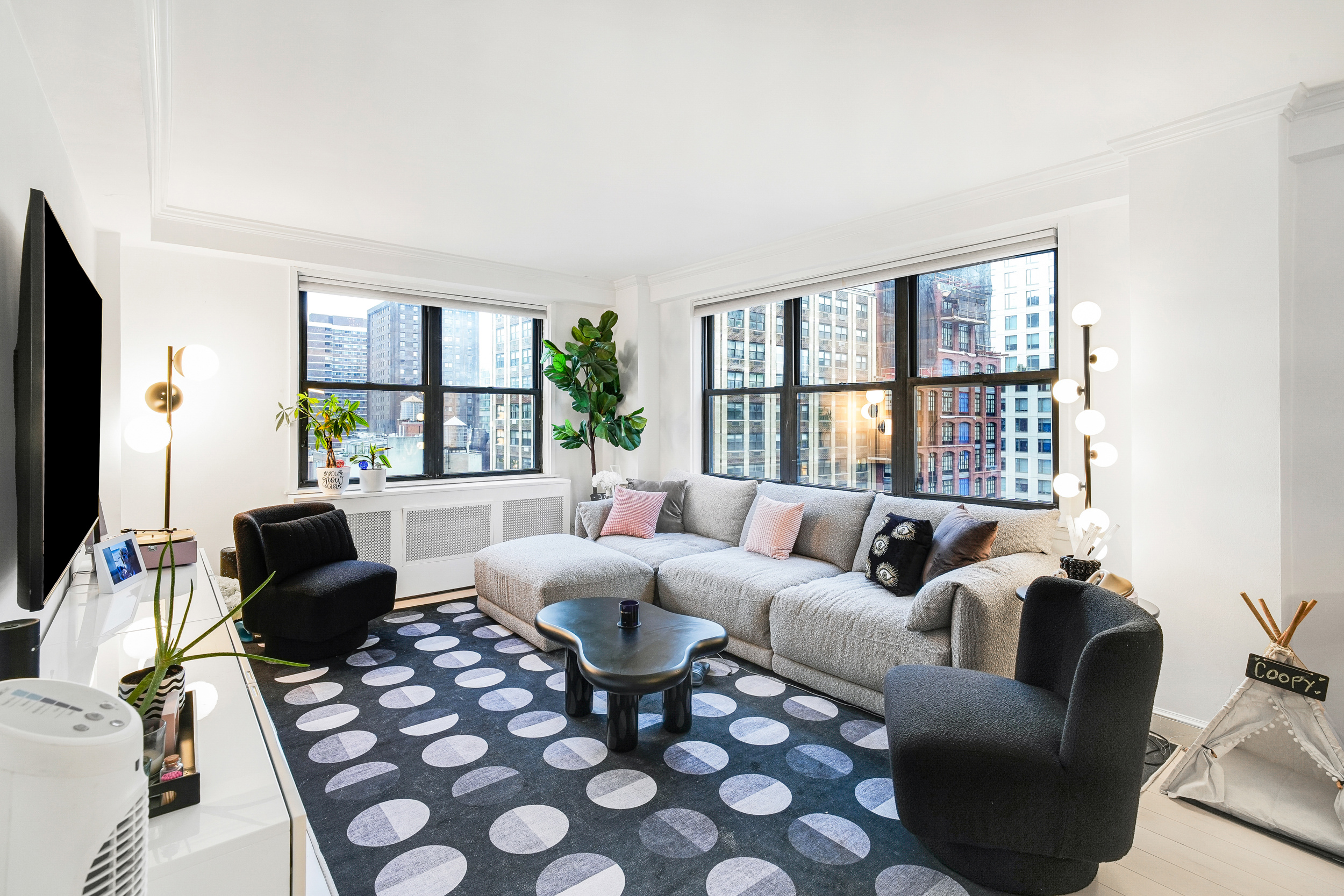 a living room with furniture large window and a flat screen tv