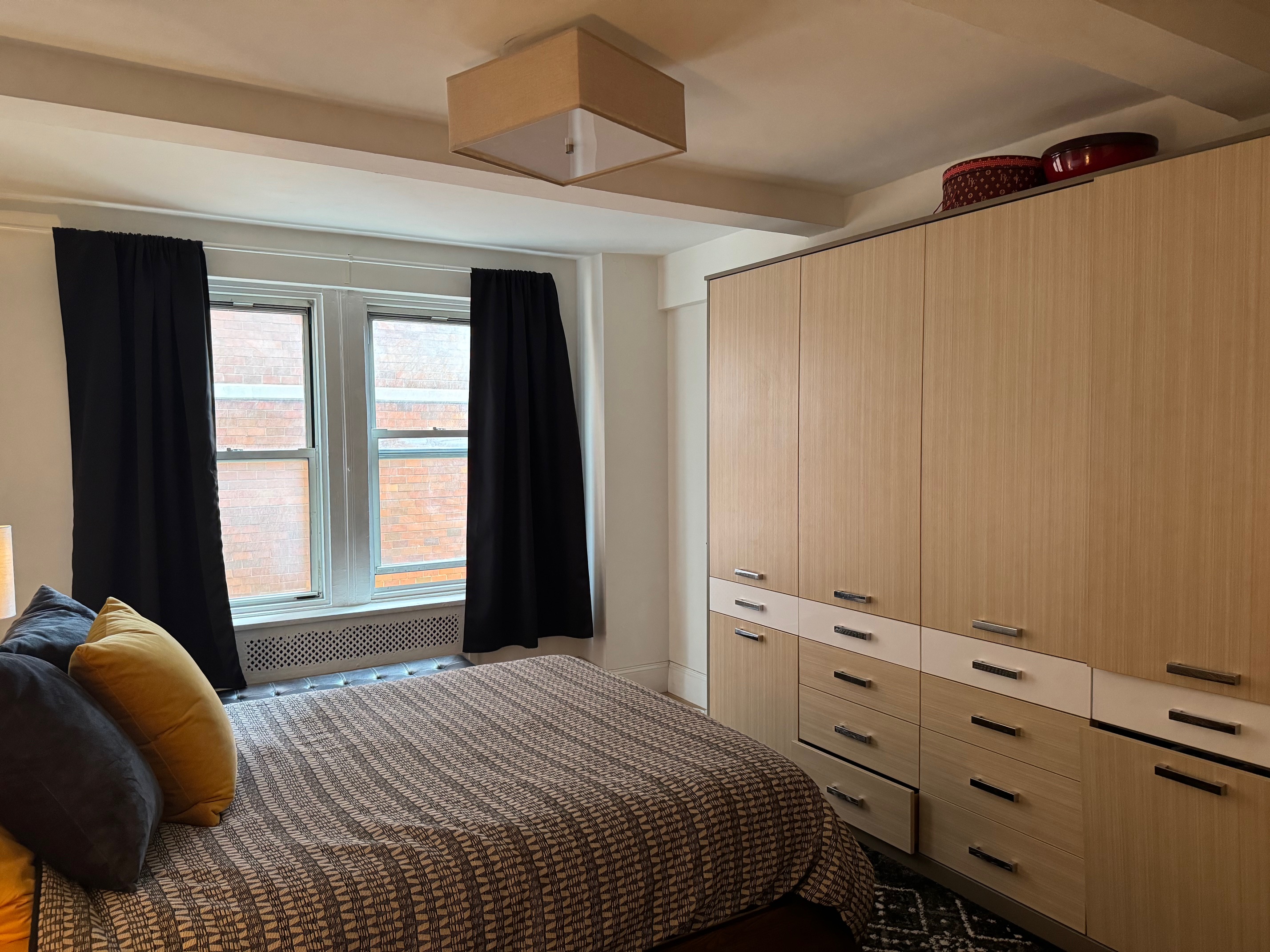 433 West 34th Street, Unit 6K Manhattan, NY 10001 - Photo 6 of 12 a bedroom with a bed and a window