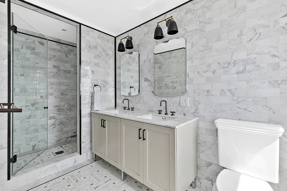 265 State Street, Unit 901 Brooklyn, NY 11201 - Photo 7 of 10 a bathroom with a shower sink mirror and toilet