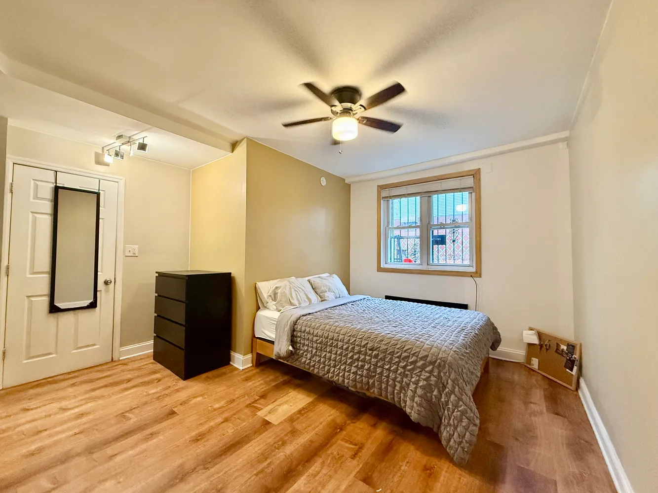 a bedroom with a bed and wooden floor