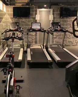 a room with gym equipment and flat screen tv