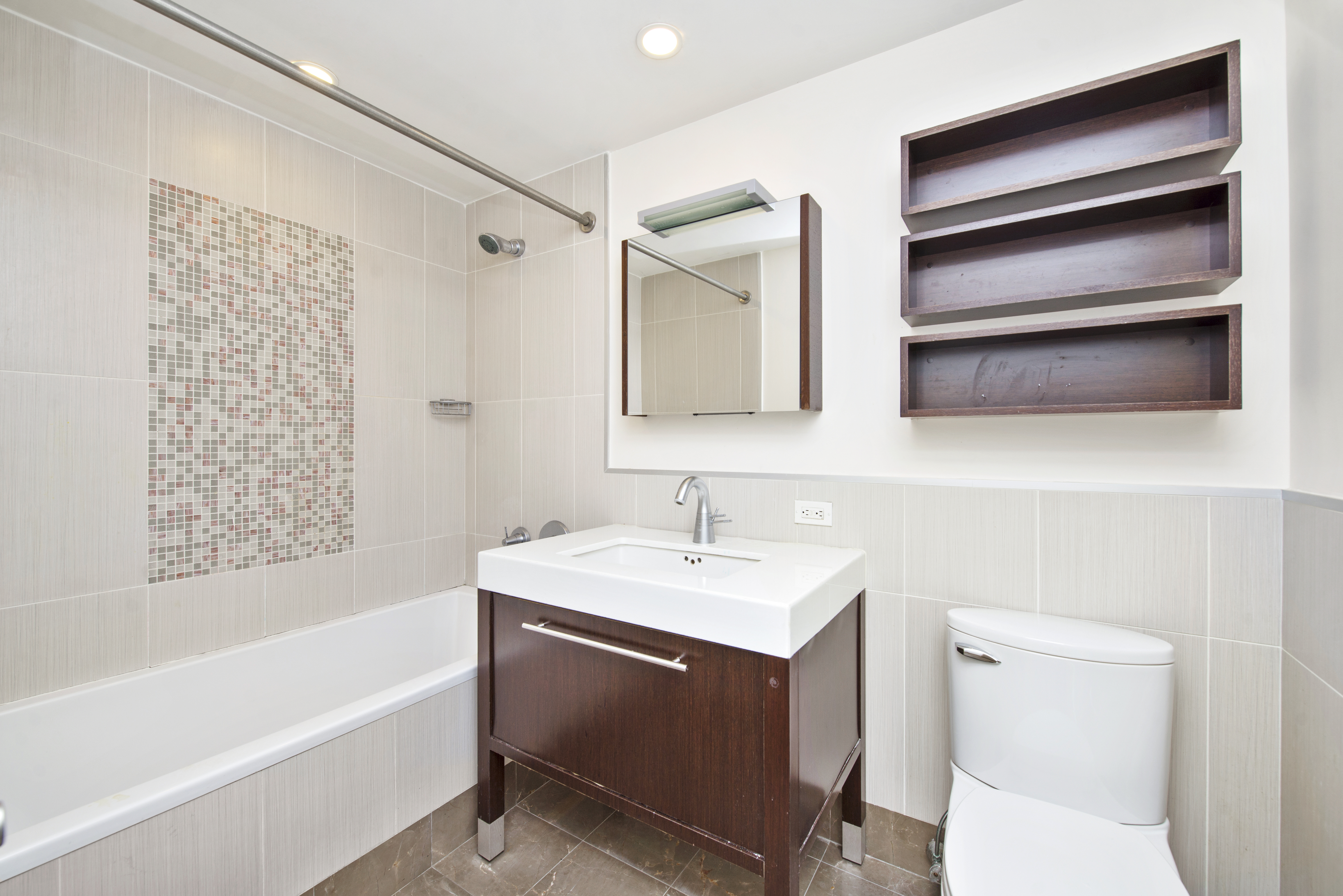225 East 34th Street, Unit 17B Manhattan, NY 10016 - Photo 11 of 24 a bathroom with a sink a toilet and shower