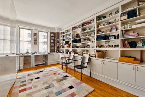 a bedroom with furniture and a book shelf
