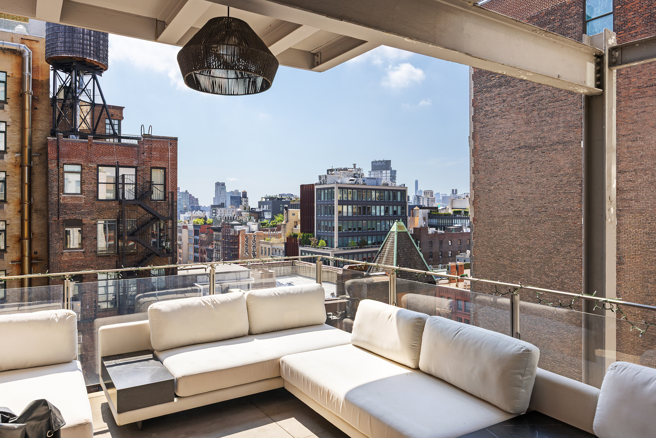 1 Great Jones Alley, Unit 10 Manhattan, NY 10012 - Photo 8 of 41 a living room with furniture and a floor to ceiling window