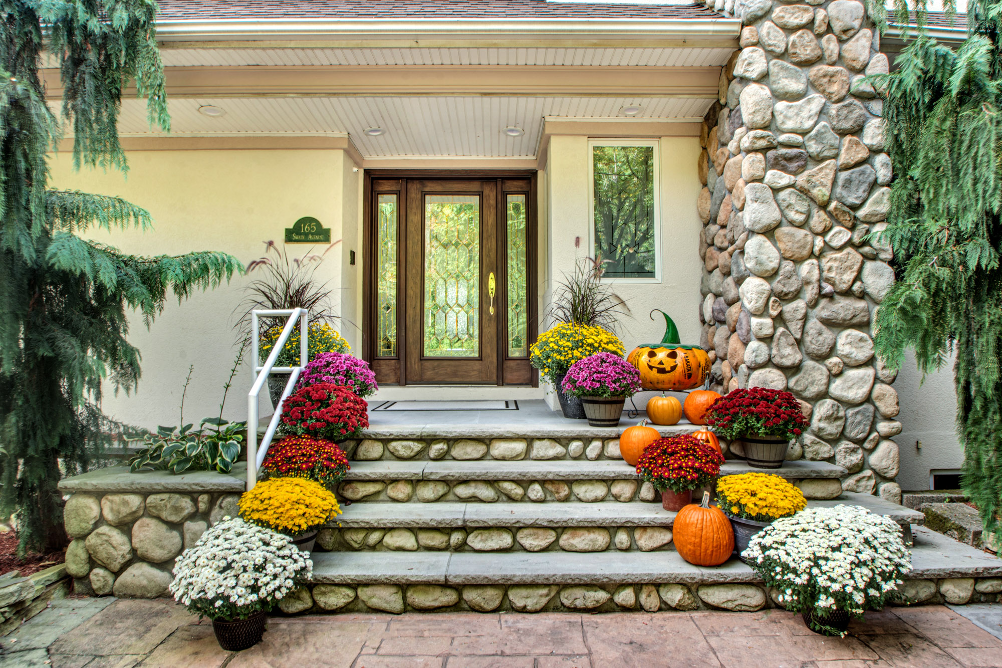 165 Swaim Avenue Staten Island, NY 10312 - Photo 2 of 45 a front view of a house with large trees and flowers