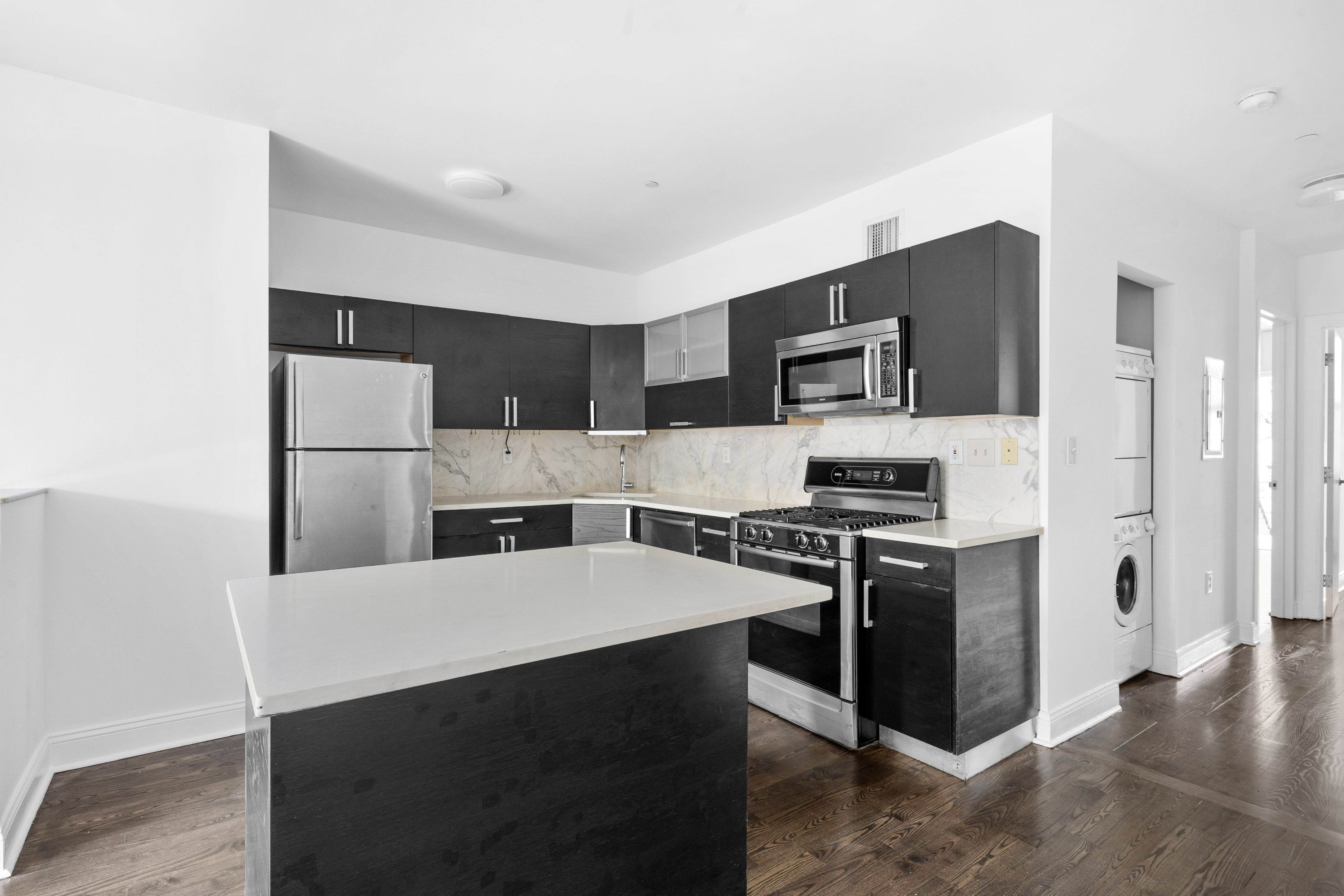 269 8th Street, Unit 2R Brooklyn, NY 11215 - Photo 5 of 14 a kitchen with stainless steel appliances a refrigerator stove microwave and sink