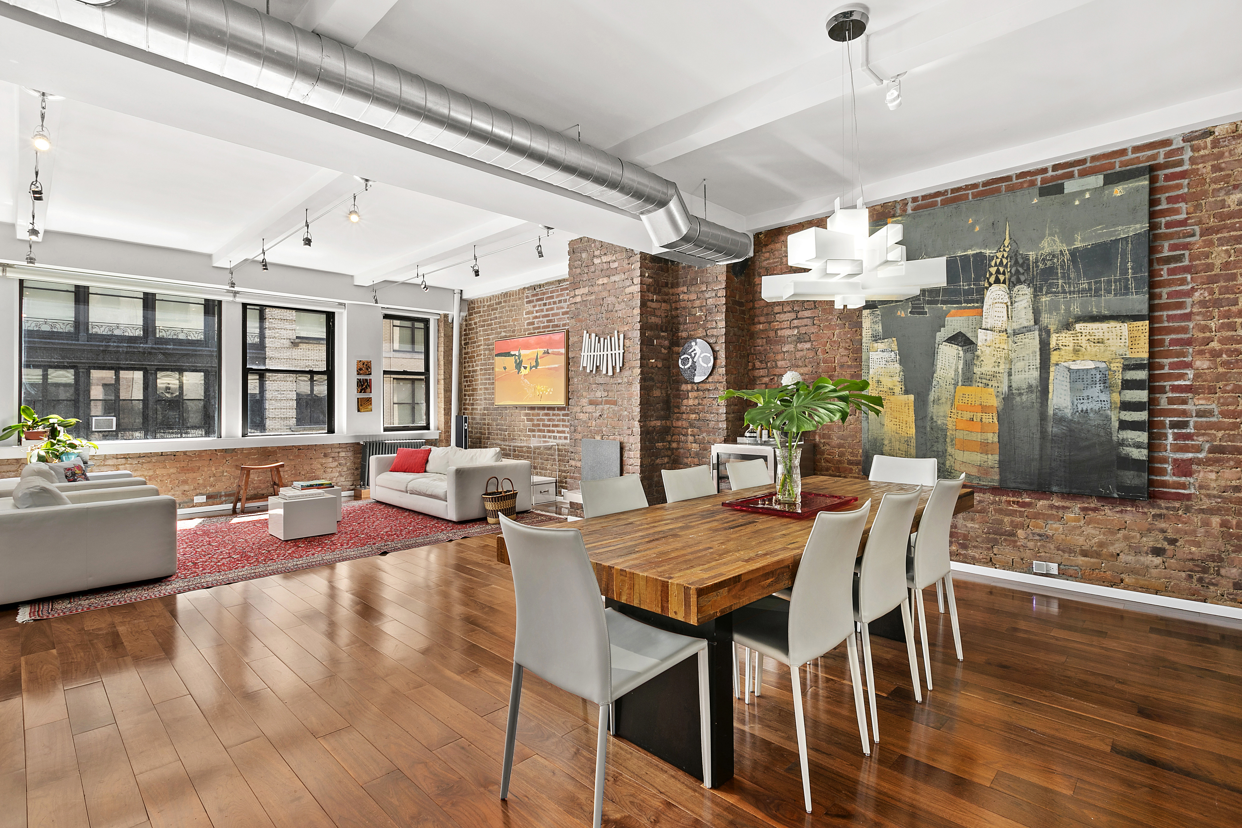 15 West 17th Street, Unit 6 Manhattan, NY 10011 - Photo 2 of 9 a view of a dining room with furniture window and wooden floor