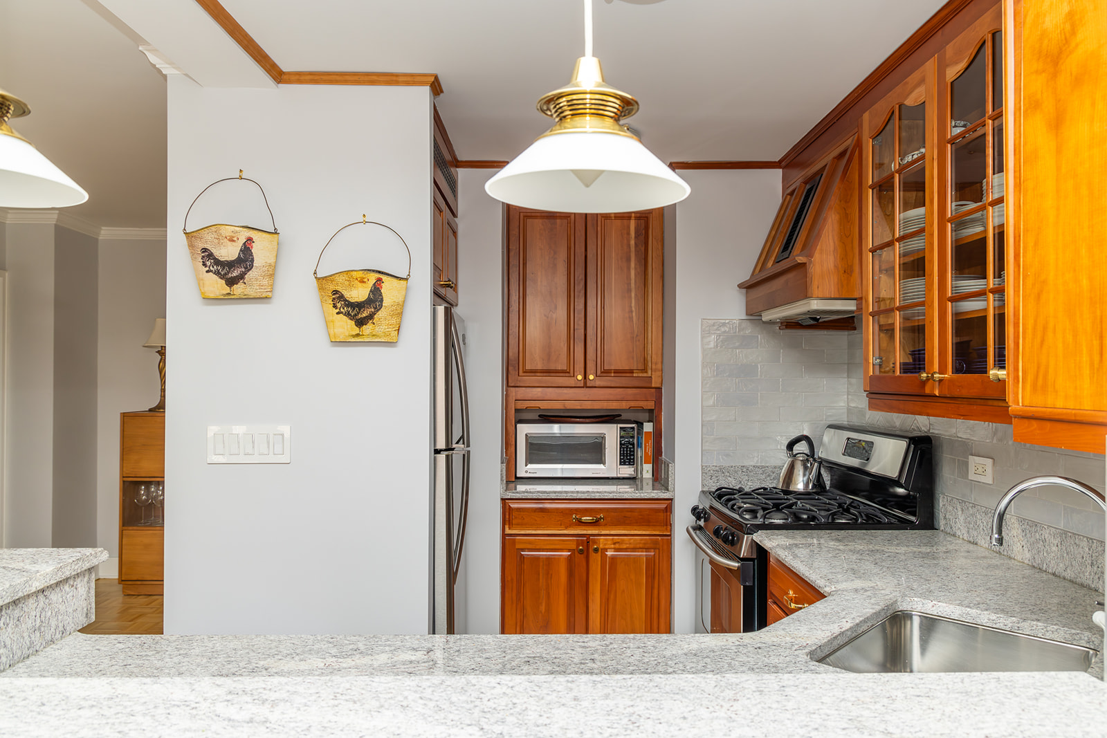 132 East 35th Street, Unit 7H Manhattan, NY 10016 - Photo 9 of 25 a kitchen with stainless steel appliances granite countertop a sink and cabinets
