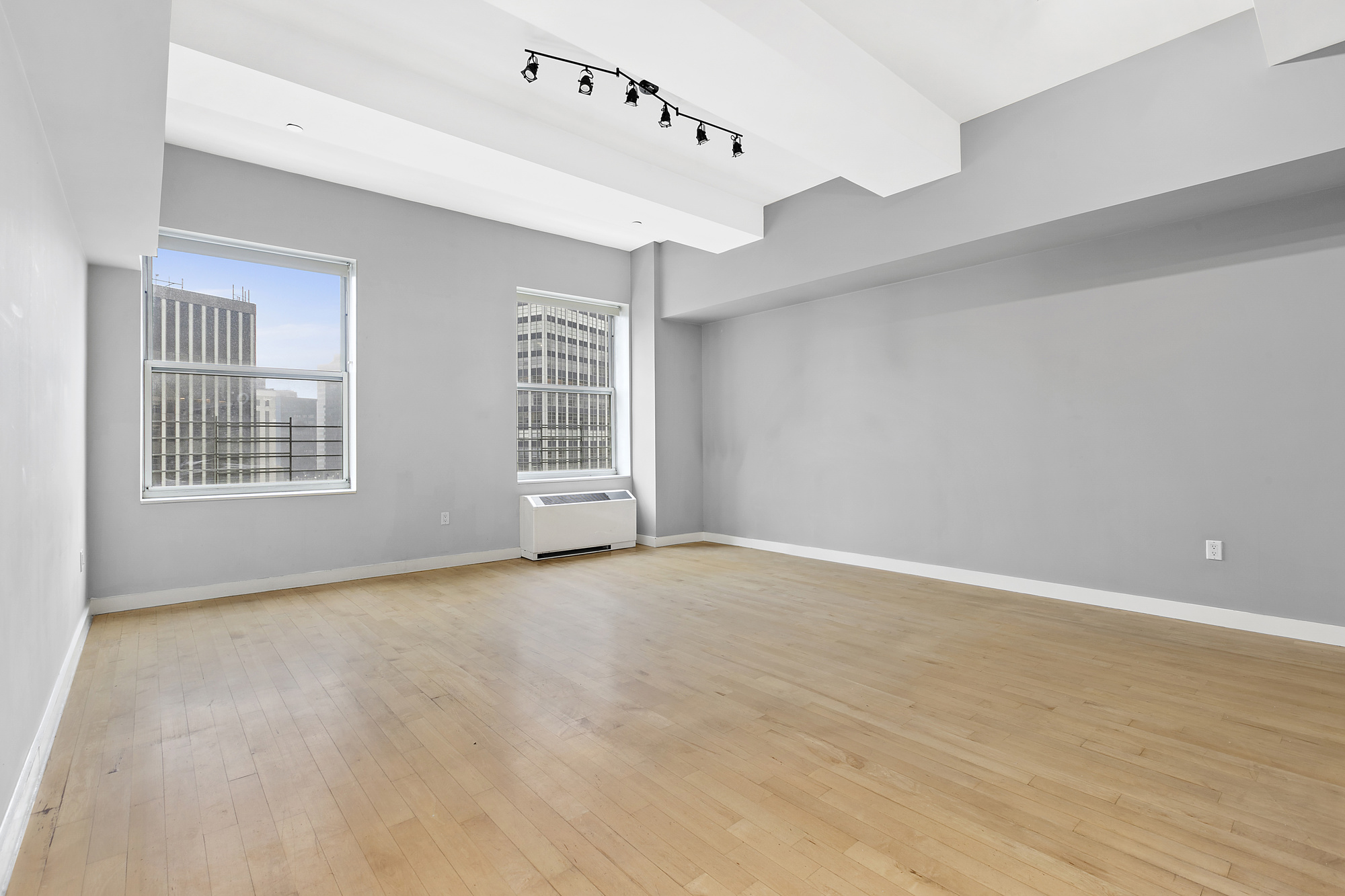 15 Broad Street, Unit 2826 Manhattan, NY 10005 - Photo 1 of 16 a view of an empty room with a window