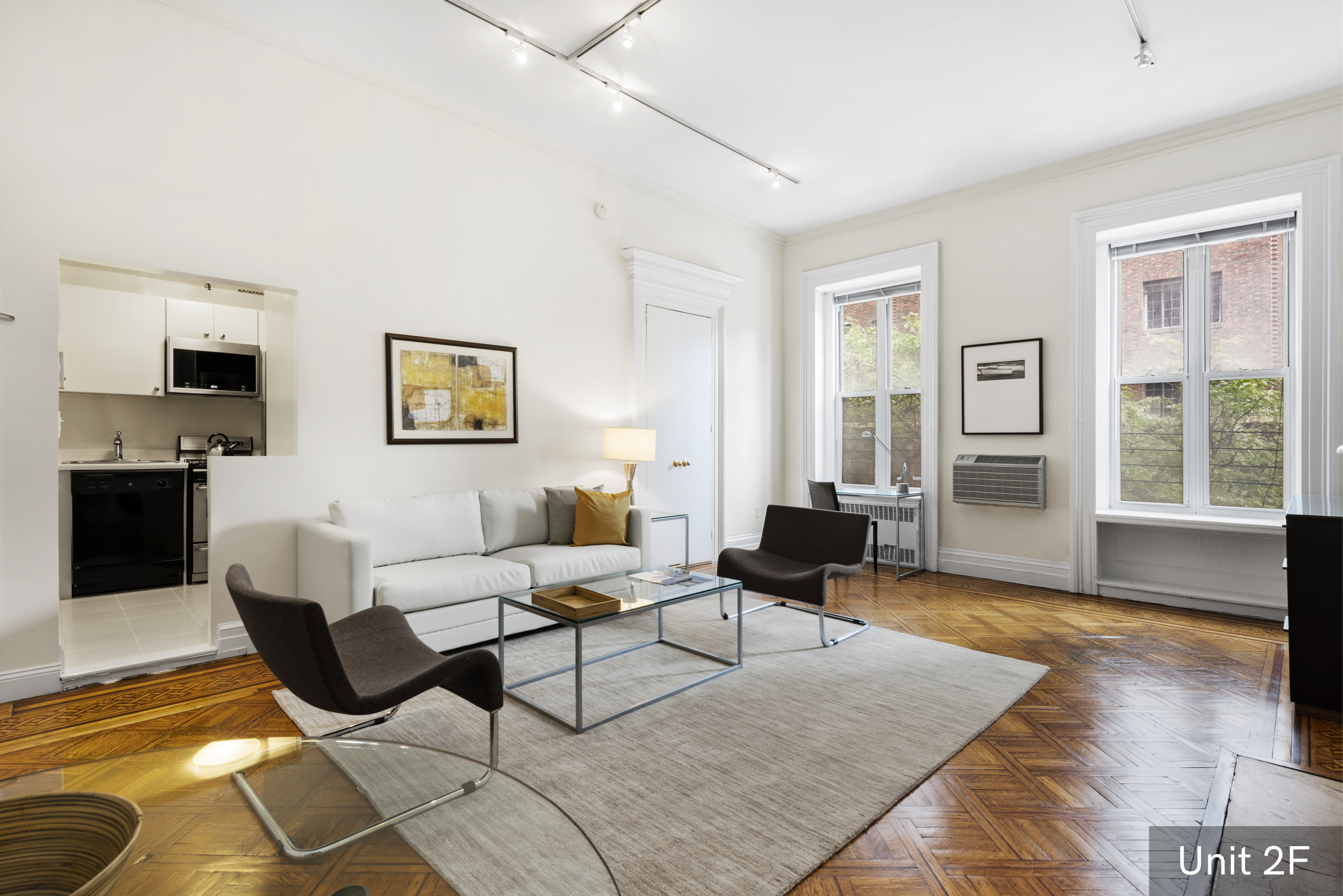 120 East 19th Street Manhattan, NY 10003 - Photo 21 of 33 a living room with furniture and wooden floor