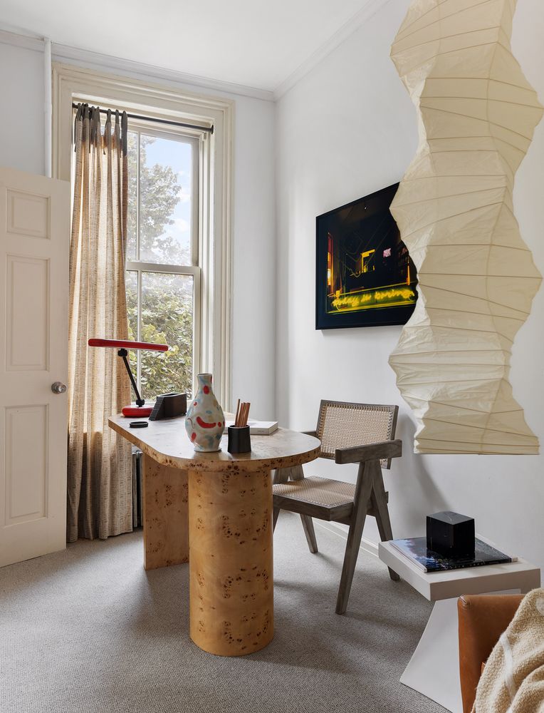 a dining room with furniture and a flat screen tv