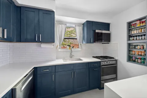 a kitchen with stainless steel appliances a stove sink and microwave