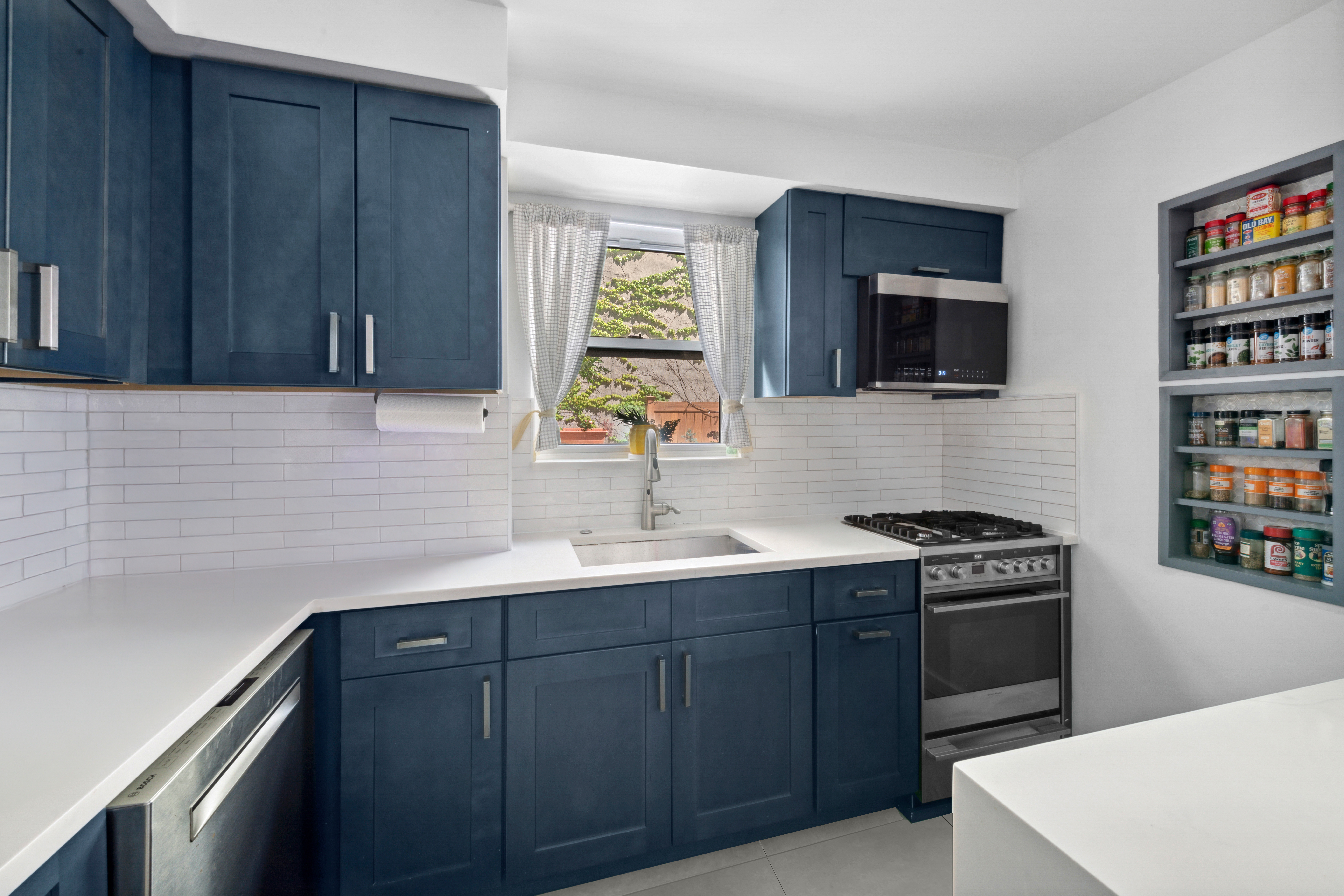 400 East 77th Street, Unit 1CD Manhattan, NY 10075 - Photo 6 of 18 a kitchen with stainless steel appliances a stove sink and microwave