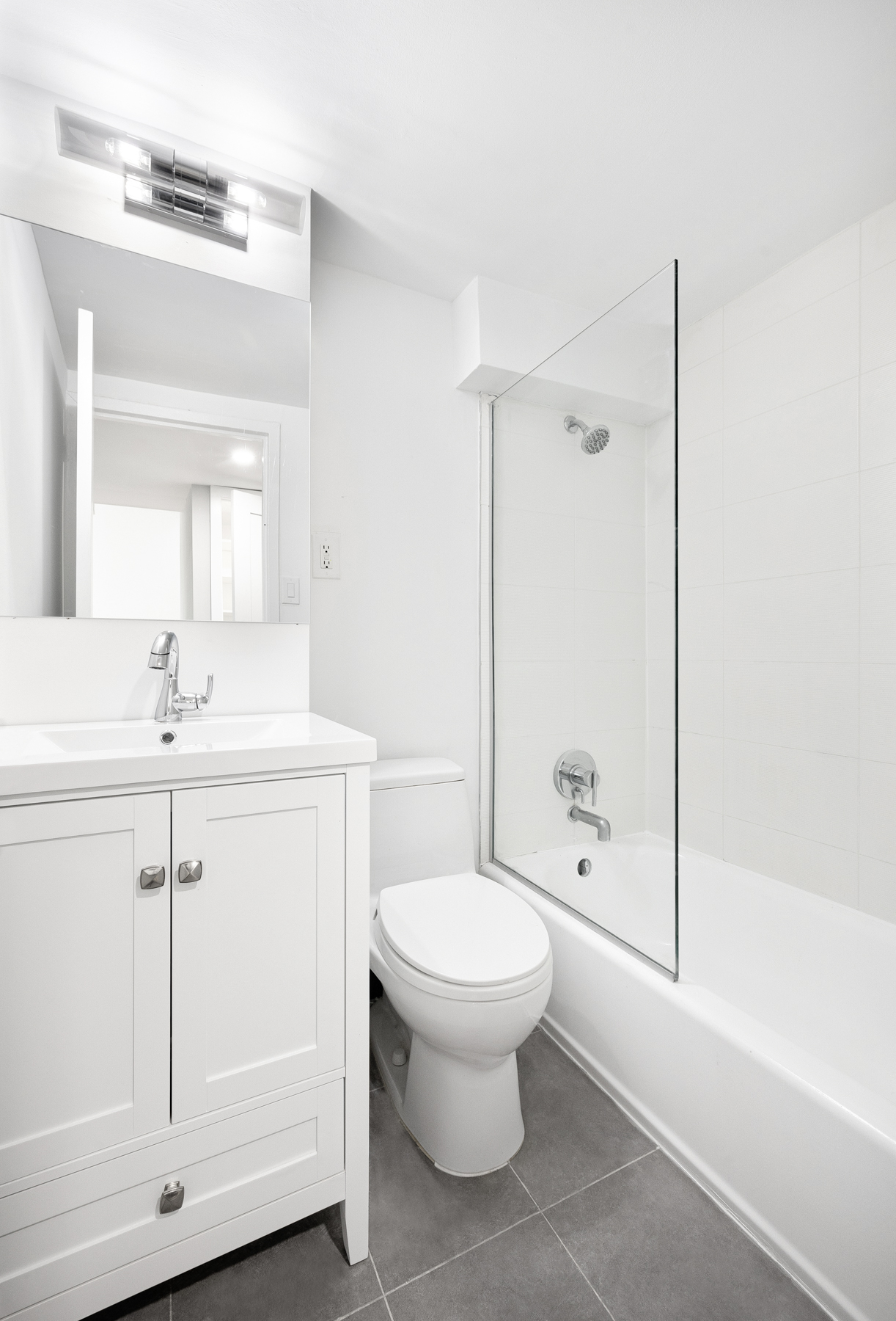 184 Thompson Street, Unit 2V Manhattan, NY 10012 - Photo 5 of 8 a bathroom with a toilet sink and shower