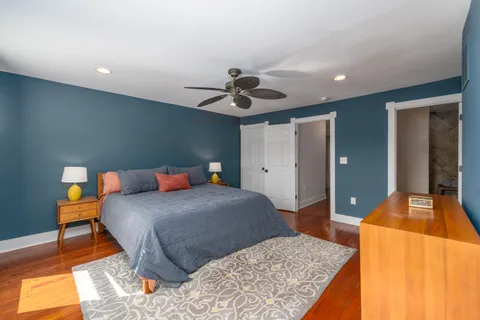 a bedroom with a bed and a chandelier