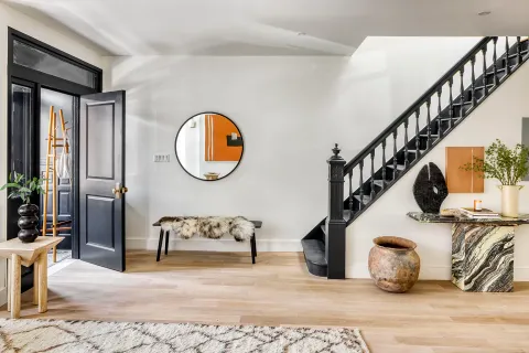 a view of entryway and hall with wooden floor