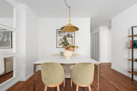 a dining room with furniture and wooden floor