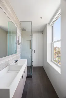 a spacious bathroom with a tub sink and mirror