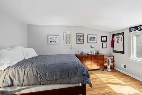 a bedroom with a bed and window