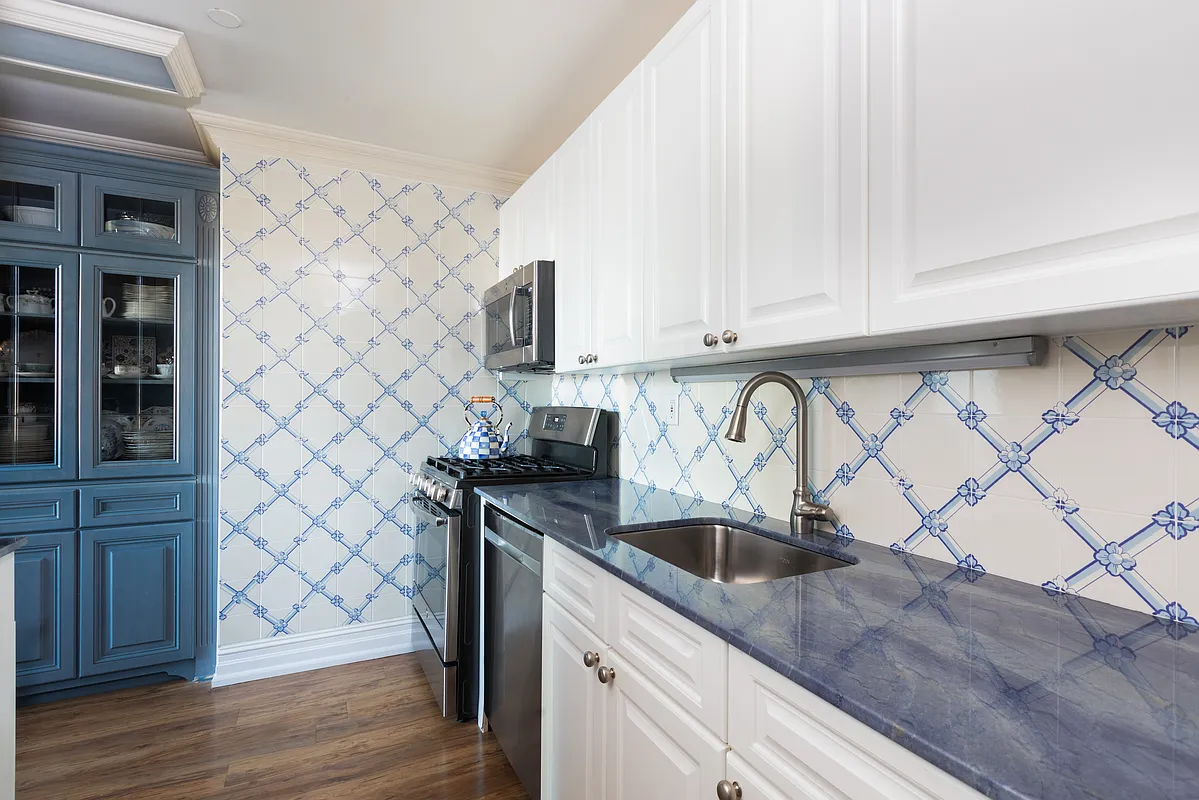 404 East 76th Street, Unit 30C Manhattan, NY 10021 - Photo 12 of 24 a kitchen with stainless steel appliances a sink a stove and cabinets