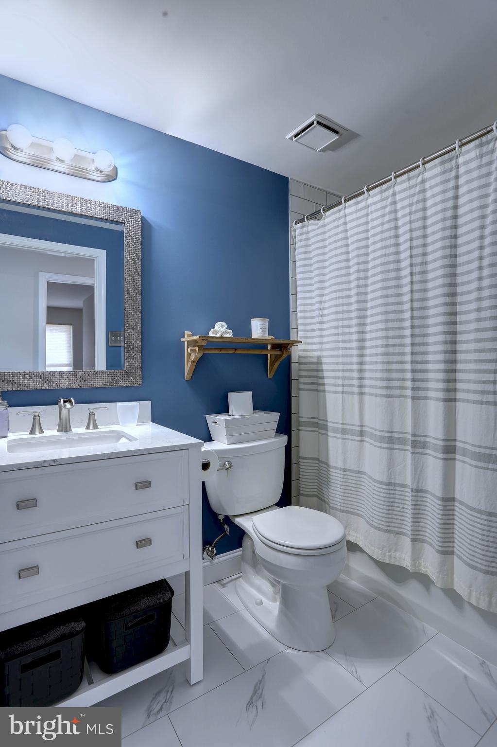 6257 Fairbourne Court Hanover, MD 21076 - Photo 38 of 47 a bathroom with a toilet sink and mirror