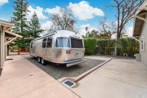 an aerial view of residential houses with outdoor space and river