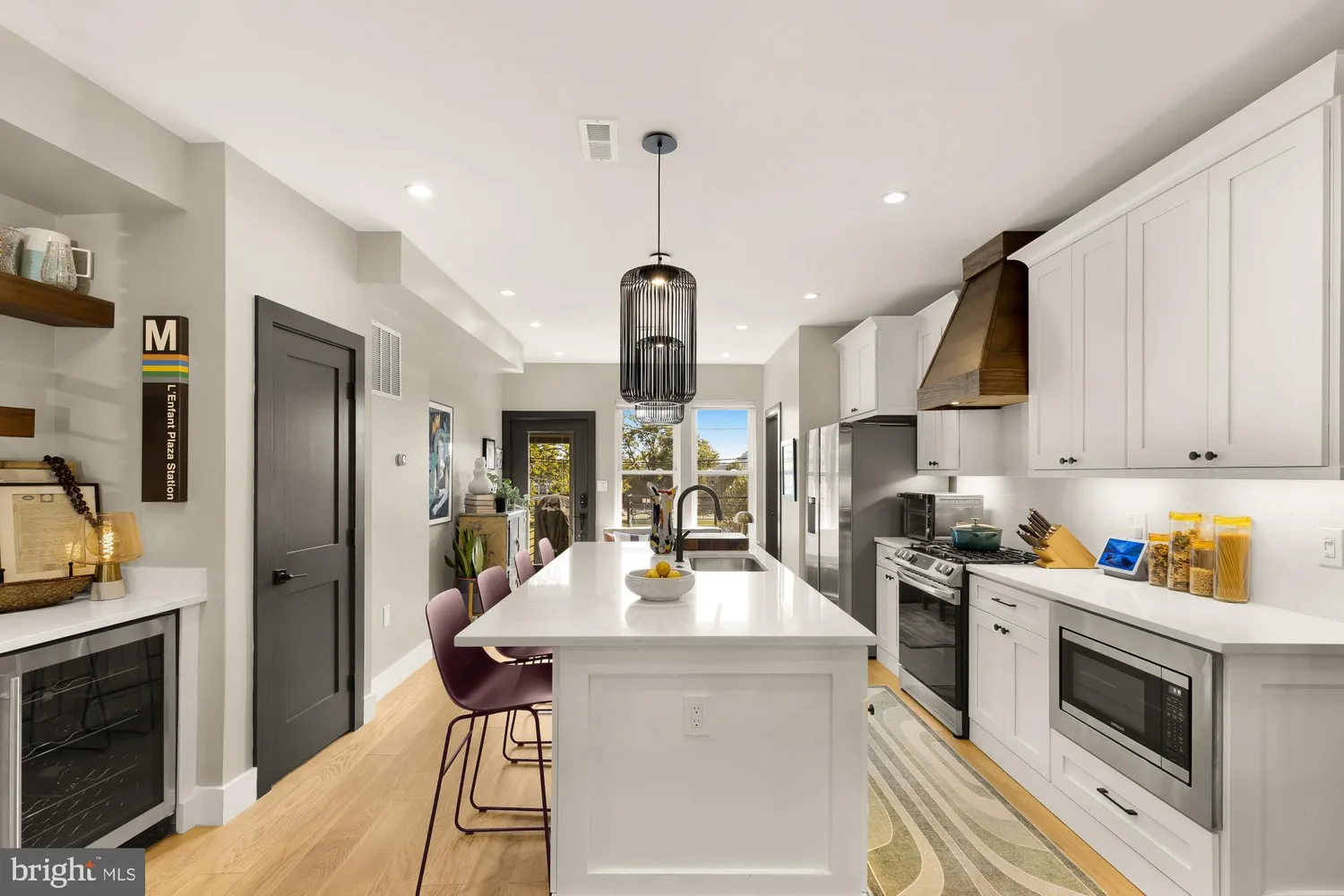 a kitchen with kitchen island a counter space a sink appliances and cabinets