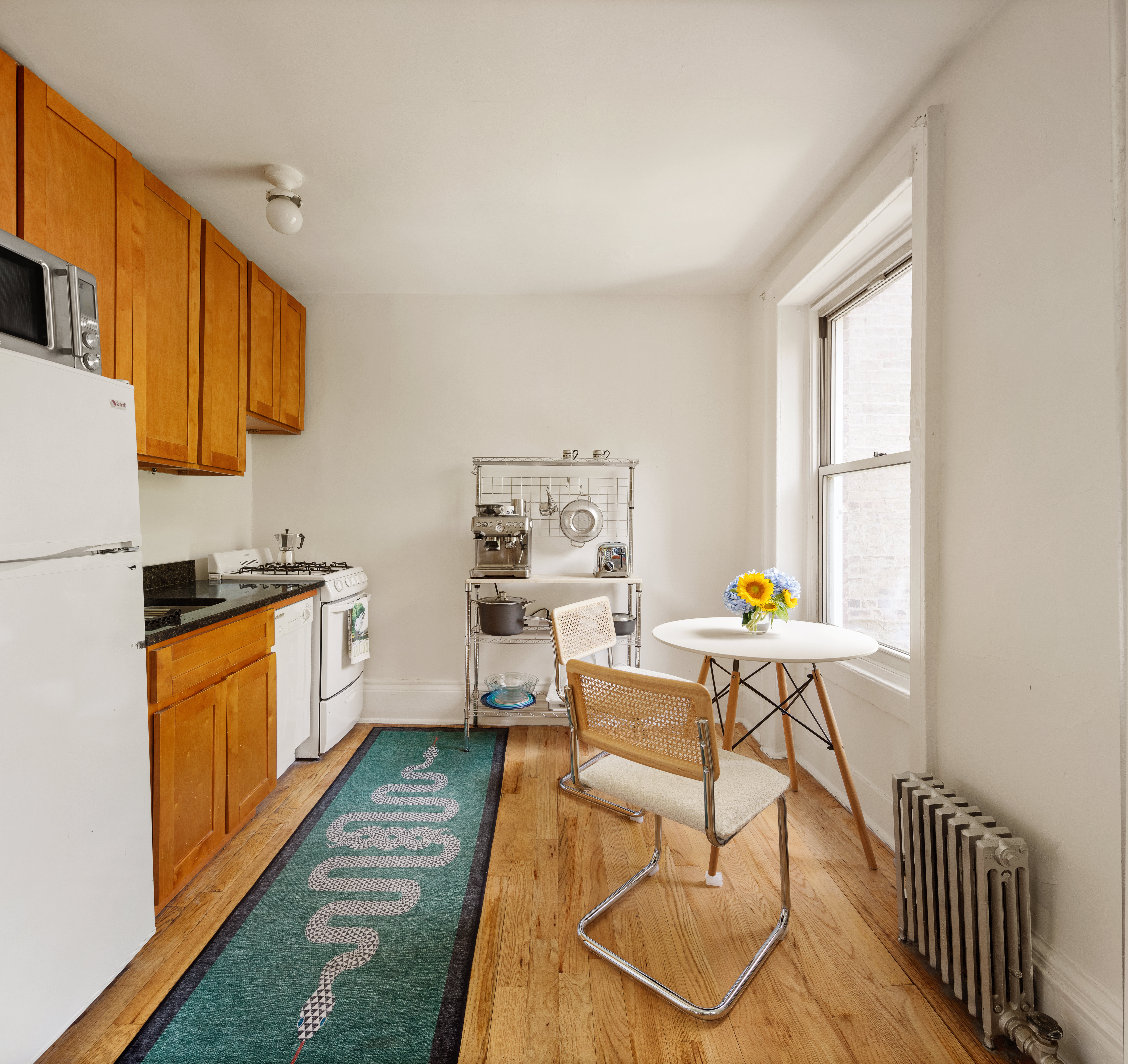 311 East 9th Street, Unit 2R Manhattan, NY 10003 - Photo 3 of 5 a kitchen with stainless steel appliances granite countertop a stove a sink and a refrigerator