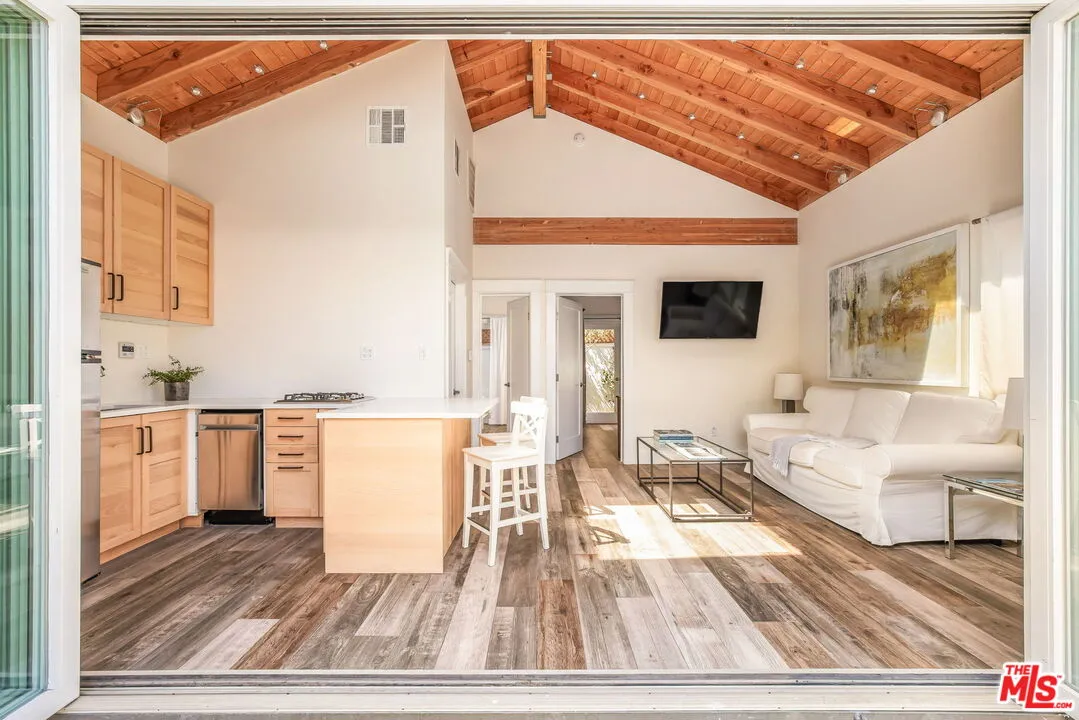 a living room with kitchen island furniture and a kitchen view