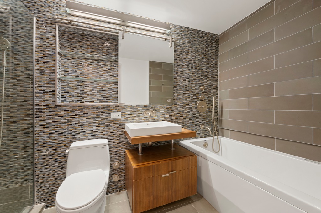2280 Frederick Douglass Boulevard, Unit 6A Manhattan, NY 10027 - Photo 7 of 13 a bathroom with a toilet a sink and bathtub
