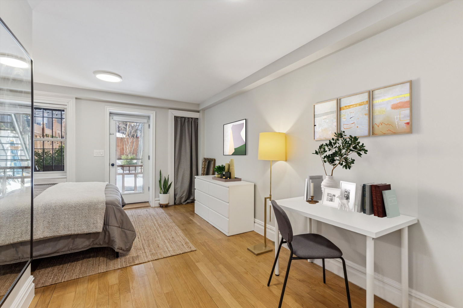318 West 140th Street, Unit GARDEN Manhattan, NY 10030 - Photo 4 of 12 a bedroom with a bed and a table