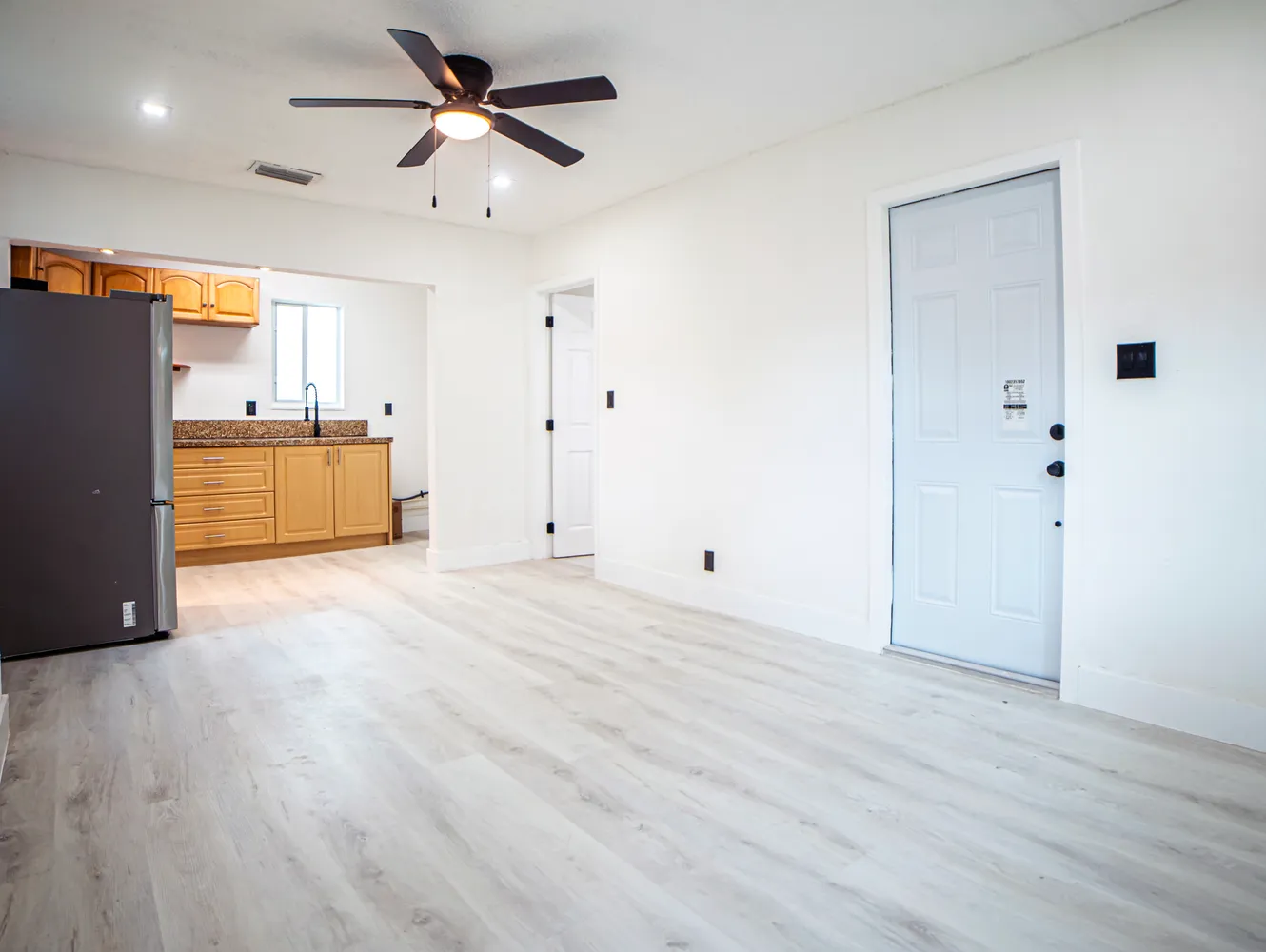 a view of a kitchen with a sink and a refrigerator